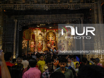 Devotees arrive to see an idol of Goddess Durga at a pandal during the Durga Puja celebration in Kolkata, India, on October 7, 2024. (