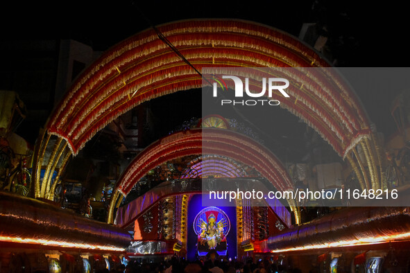 Devotees arrive to see an idol of Goddess Durga at a pandal during the Durga Puja celebration in Kolkata, India, on October 7, 2024. 