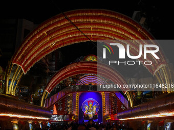 Devotees arrive to see an idol of Goddess Durga at a pandal during the Durga Puja celebration in Kolkata, India, on October 7, 2024. (