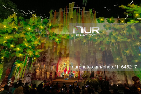 Devotees arrive to see an idol of Goddess Durga at a pandal during the Durga Puja celebration in Kolkata, India, on October 7, 2024. 