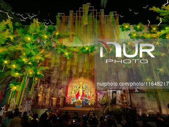 Devotees arrive to see an idol of Goddess Durga at a pandal during the Durga Puja celebration in Kolkata, India, on October 7, 2024. (