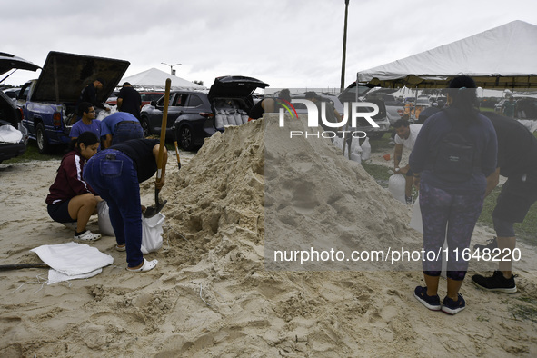 Residents of Orange County, Florida, collect sandbags for free to protect themselves from Hurricane Milton, which is expected this week. The...