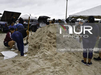 Residents of Orange County, Florida, collect sandbags for free to protect themselves from Hurricane Milton, which is expected this week. The...