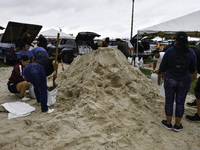 Residents of Orange County, Florida, collect sandbags for free to protect themselves from Hurricane Milton, which is expected this week. The...