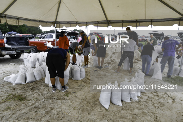 Residents of Orange County, Florida, collect sandbags for free to protect themselves from Hurricane Milton, which is expected this week. The...