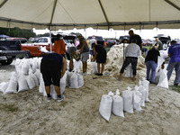 Residents of Orange County, Florida, collect sandbags for free to protect themselves from Hurricane Milton, which is expected this week. The...