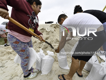 Residents of Orange County, Florida, collect sandbags for free to protect themselves from Hurricane Milton, which is expected this week. The...