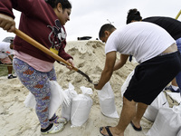 Residents of Orange County, Florida, collect sandbags for free to protect themselves from Hurricane Milton, which is expected this week. The...