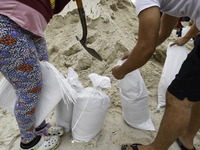 Residents of Orange County, Florida, collect sandbags for free to protect themselves from Hurricane Milton, which is expected this week. The...