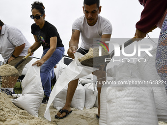 Residents of Orange County, Florida, collect sandbags for free to protect themselves from Hurricane Milton, which is expected this week. The...