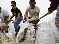 Residents of Orange County, Florida, collect sandbags for free to protect themselves from Hurricane Milton, which is expected this week. The...