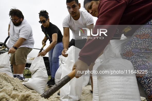 Residents of Orange County, Florida, collect sandbags for free to protect themselves from Hurricane Milton, which is expected this week. The...