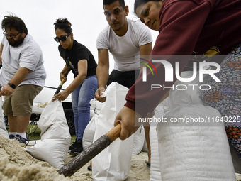 Residents of Orange County, Florida, collect sandbags for free to protect themselves from Hurricane Milton, which is expected this week. The...