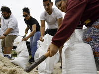 Residents of Orange County, Florida, collect sandbags for free to protect themselves from Hurricane Milton, which is expected this week. The...