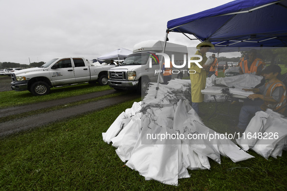 Residents of Orange County, Florida, collect sandbags for free to protect themselves from Hurricane Milton, which is expected this week. The...