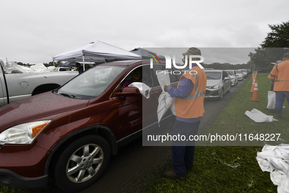 Residents of Orange County, Florida, collect sandbags for free to protect themselves from Hurricane Milton, which is expected this week. The...