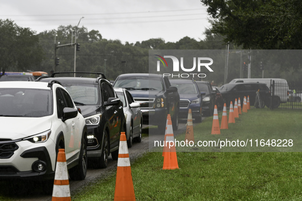 Residents of Orange County, Florida, collect sandbags for free to protect themselves from Hurricane Milton, which is expected this week. The...