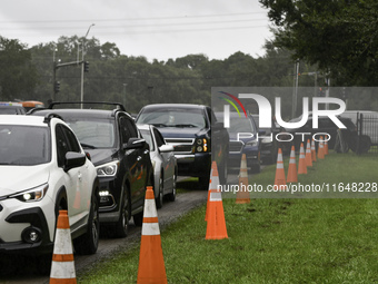 Residents of Orange County, Florida, collect sandbags for free to protect themselves from Hurricane Milton, which is expected this week. The...