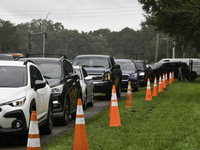 Residents of Orange County, Florida, collect sandbags for free to protect themselves from Hurricane Milton, which is expected this week. The...