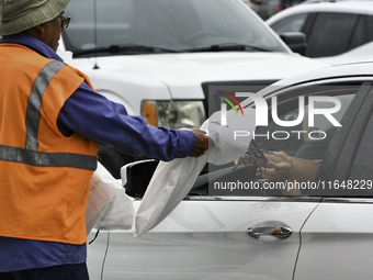 Residents of Orange County, Florida, collect sandbags for free to protect themselves from Hurricane Milton, which is expected this week. The...