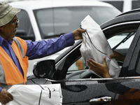 Residents of Orange County, Florida, collect sandbags for free to protect themselves from Hurricane Milton, which is expected this week. The...