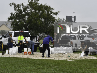 Residents of Orange County, Florida, collect sandbags for free to protect themselves from Hurricane Milton, which is expected this week. The...