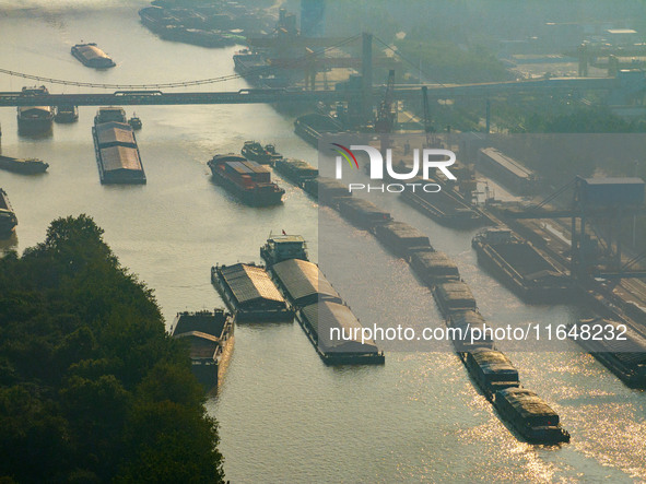 In Huai'an, China, on October 8, 2024, a photo shows transport ships in the port, dock, and river of the Beijing-Hangzhou Grand Canal in Hua...