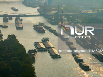 In Huai'an, China, on October 8, 2024, a photo shows transport ships in the port, dock, and river of the Beijing-Hangzhou Grand Canal in Hua...