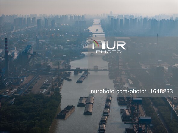 In Huai'an, China, on October 8, 2024, a photo shows transport ships in the port, dock, and river of the Beijing-Hangzhou Grand Canal in Hua...