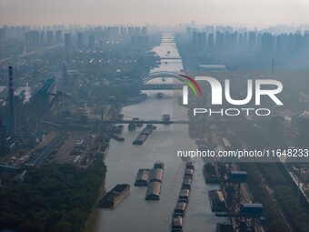 In Huai'an, China, on October 8, 2024, a photo shows transport ships in the port, dock, and river of the Beijing-Hangzhou Grand Canal in Hua...