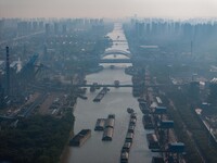 In Huai'an, China, on October 8, 2024, a photo shows transport ships in the port, dock, and river of the Beijing-Hangzhou Grand Canal in Hua...