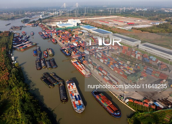 In Huai'an, China, on October 8, 2024, a photo shows transport ships in the port, dock, and river of the Beijing-Hangzhou Grand Canal in Hua...