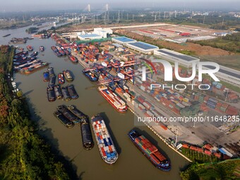 In Huai'an, China, on October 8, 2024, a photo shows transport ships in the port, dock, and river of the Beijing-Hangzhou Grand Canal in Hua...