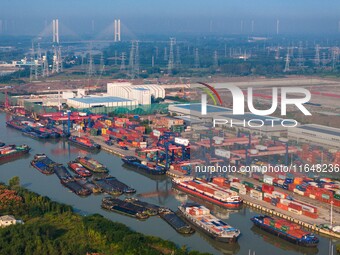 In Huai'an, China, on October 8, 2024, a photo shows transport ships in the port, dock, and river of the Beijing-Hangzhou Grand Canal in Hua...