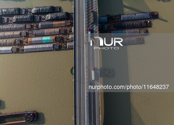 In Huai'an, China, on October 8, 2024, a photo shows transport ships in the port, dock, and river of the Beijing-Hangzhou Grand Canal in Hua...