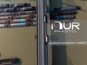 In Huai'an, China, on October 8, 2024, a photo shows transport ships in the port, dock, and river of the Beijing-Hangzhou Grand Canal in Hua...