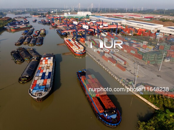 In Huai'an, China, on October 8, 2024, a photo shows transport ships in the port, dock, and river of the Beijing-Hangzhou Grand Canal in Hua...