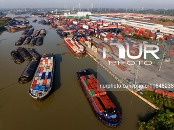 In Huai'an, China, on October 8, 2024, a photo shows transport ships in the port, dock, and river of the Beijing-Hangzhou Grand Canal in Hua...