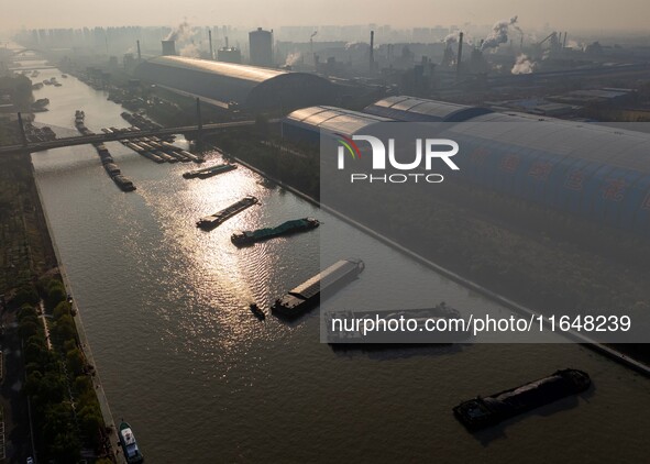 In Huai'an, China, on October 8, 2024, a photo shows transport ships in the port, dock, and river of the Beijing-Hangzhou Grand Canal in Hua...