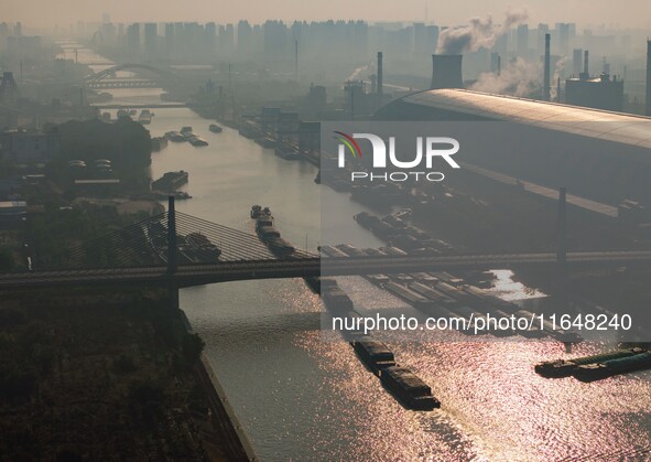 In Huai'an, China, on October 8, 2024, a photo shows transport ships in the port, dock, and river of the Beijing-Hangzhou Grand Canal in Hua...