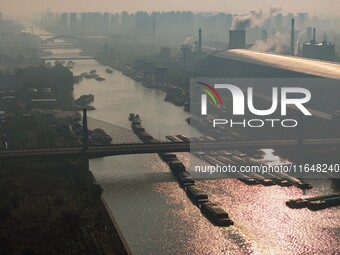 In Huai'an, China, on October 8, 2024, a photo shows transport ships in the port, dock, and river of the Beijing-Hangzhou Grand Canal in Hua...