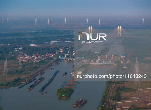 In Huai'an, China, on October 8, 2024, a photo shows transport ships in the port, dock, and river of the Beijing-Hangzhou Grand Canal in Hua...