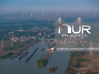 In Huai'an, China, on October 8, 2024, a photo shows transport ships in the port, dock, and river of the Beijing-Hangzhou Grand Canal in Hua...