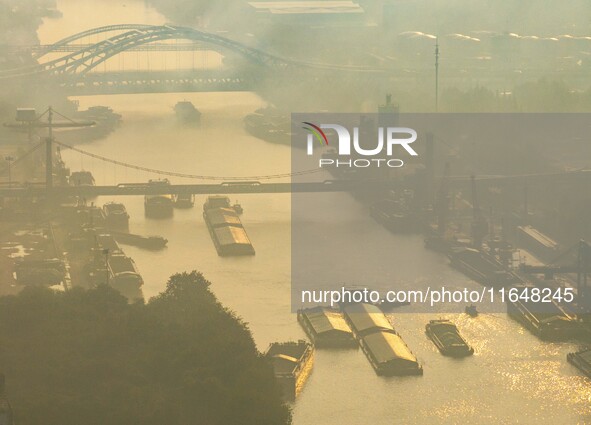 In Huai'an, China, on October 8, 2024, a photo shows transport ships in the port, dock, and river of the Beijing-Hangzhou Grand Canal in Hua...