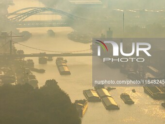 In Huai'an, China, on October 8, 2024, a photo shows transport ships in the port, dock, and river of the Beijing-Hangzhou Grand Canal in Hua...