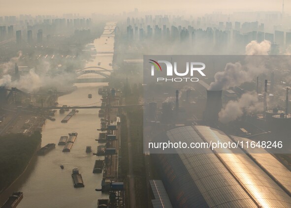 In Huai'an, China, on October 8, 2024, a photo shows transport ships in the port, dock, and river of the Beijing-Hangzhou Grand Canal in Hua...