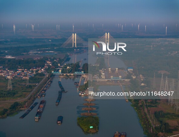 In Huai'an, China, on October 8, 2024, a photo shows transport ships in the port, dock, and river of the Beijing-Hangzhou Grand Canal in Hua...