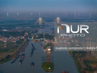 In Huai'an, China, on October 8, 2024, a photo shows transport ships in the port, dock, and river of the Beijing-Hangzhou Grand Canal in Hua...