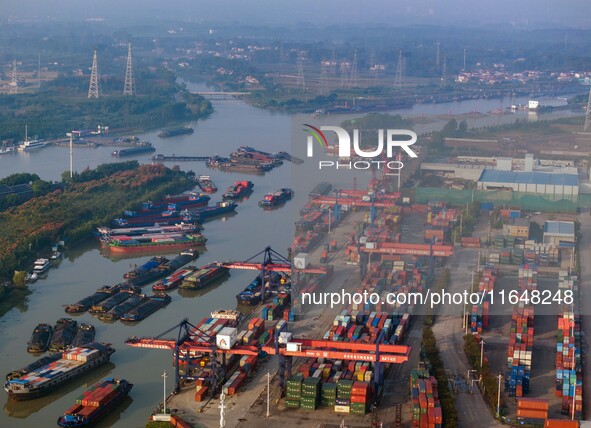 In Huai'an, China, on October 8, 2024, a photo shows transport ships in the port, dock, and river of the Beijing-Hangzhou Grand Canal in Hua...