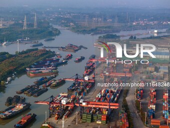 In Huai'an, China, on October 8, 2024, a photo shows transport ships in the port, dock, and river of the Beijing-Hangzhou Grand Canal in Hua...